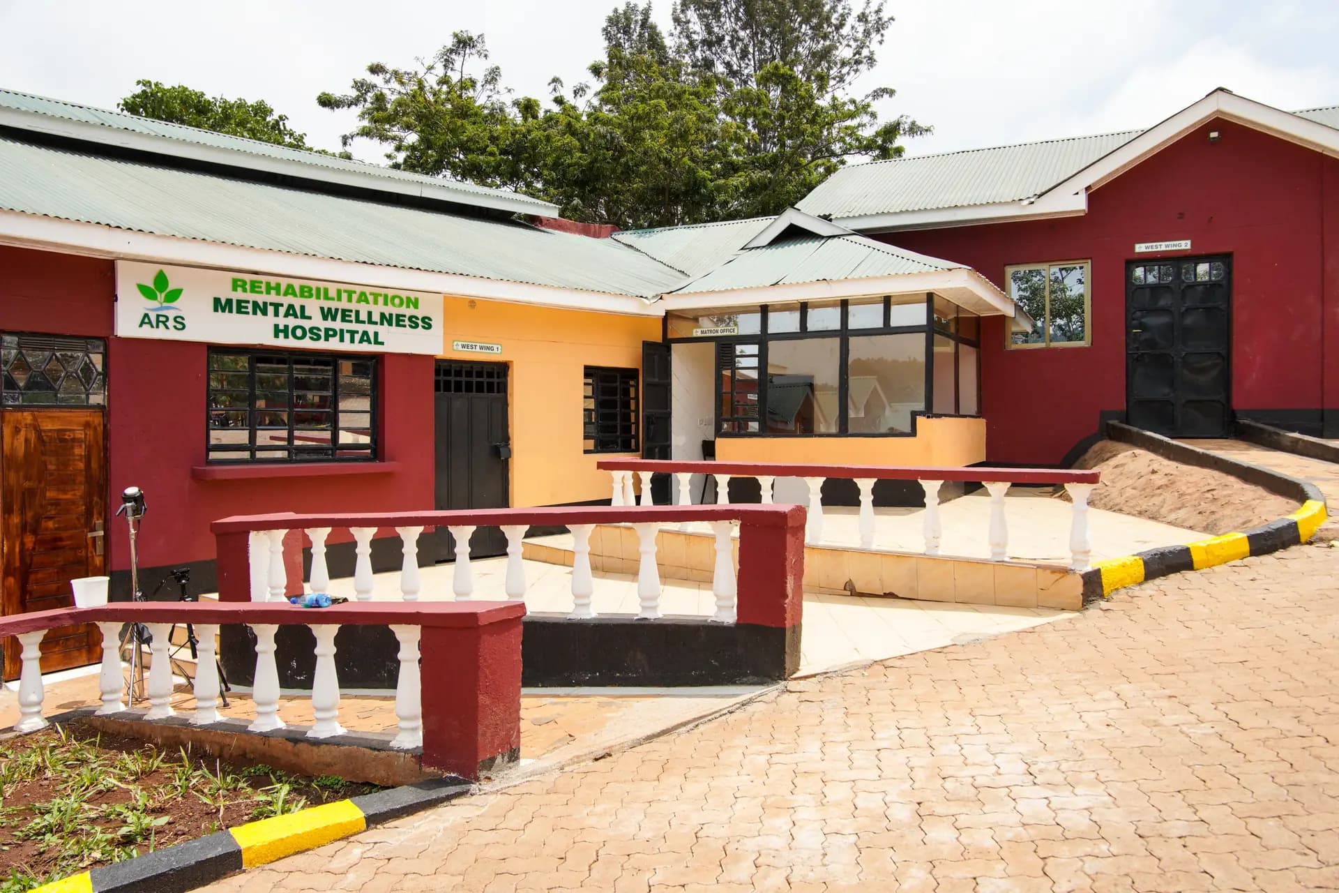 Main hospital building and front approach at ARS Mental Wellness Rehabilitation Hospital.